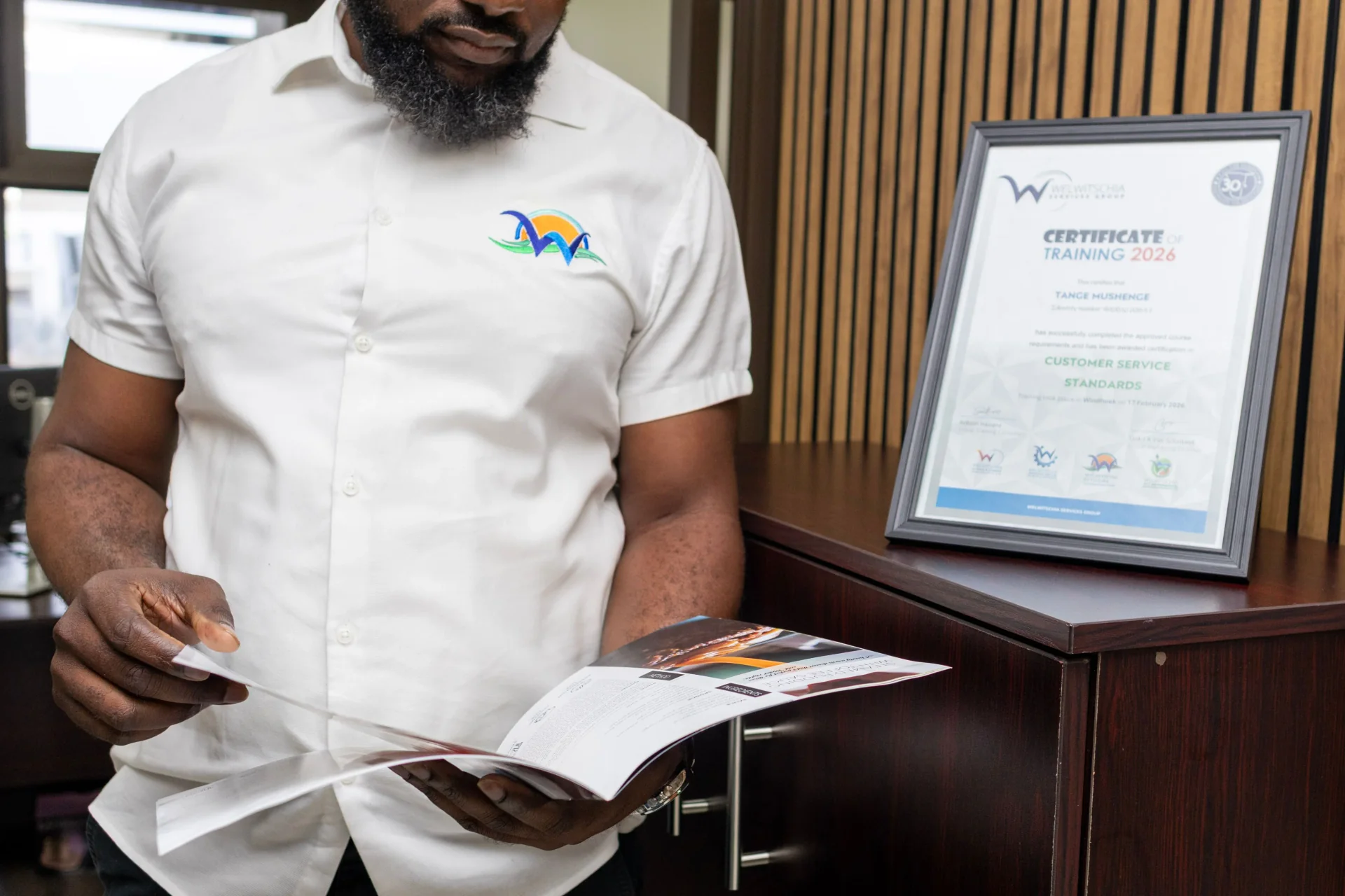 WOFM team member reviewing training certification materials