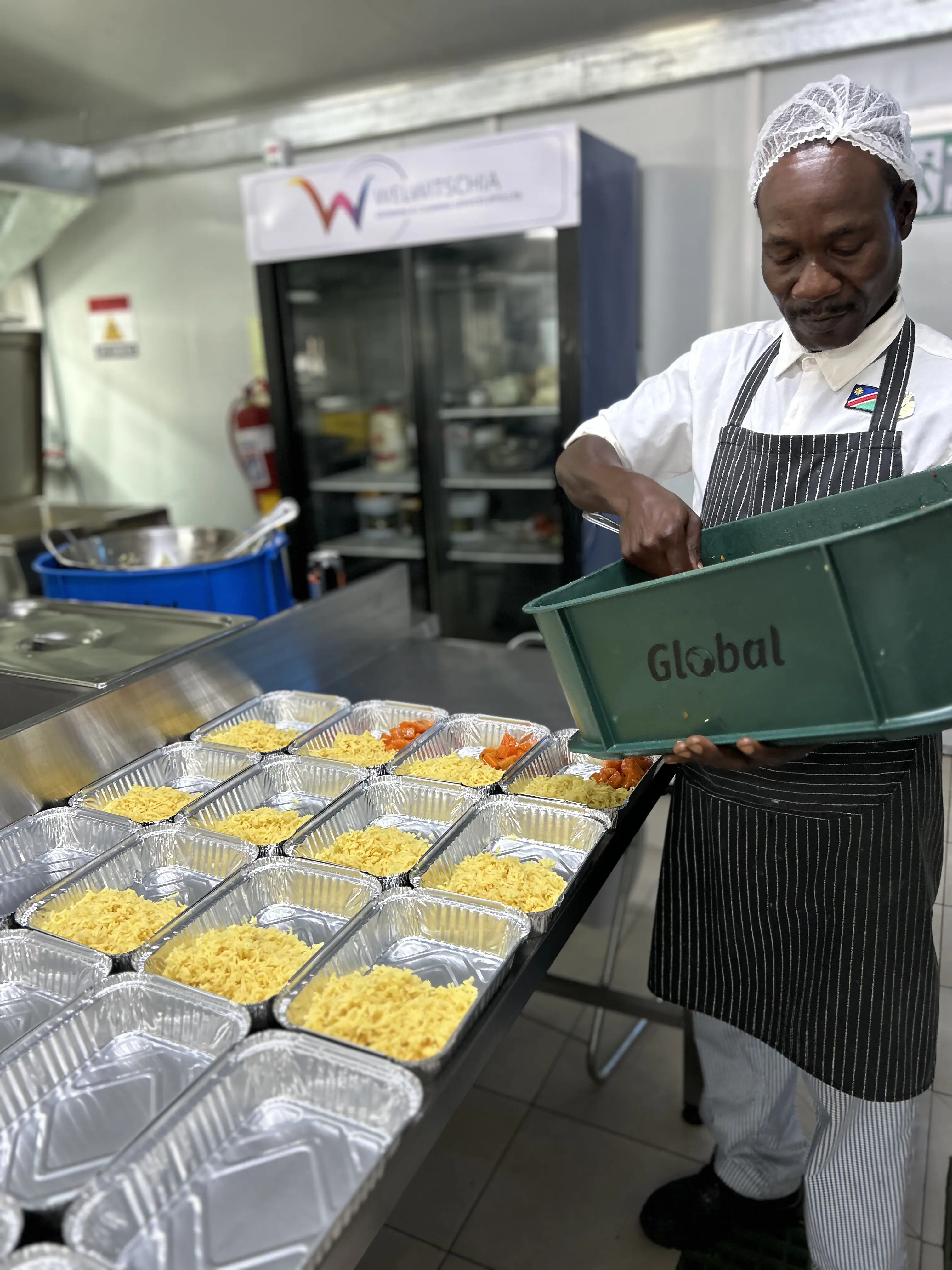 WCCS catering team preparing packaged meals for service